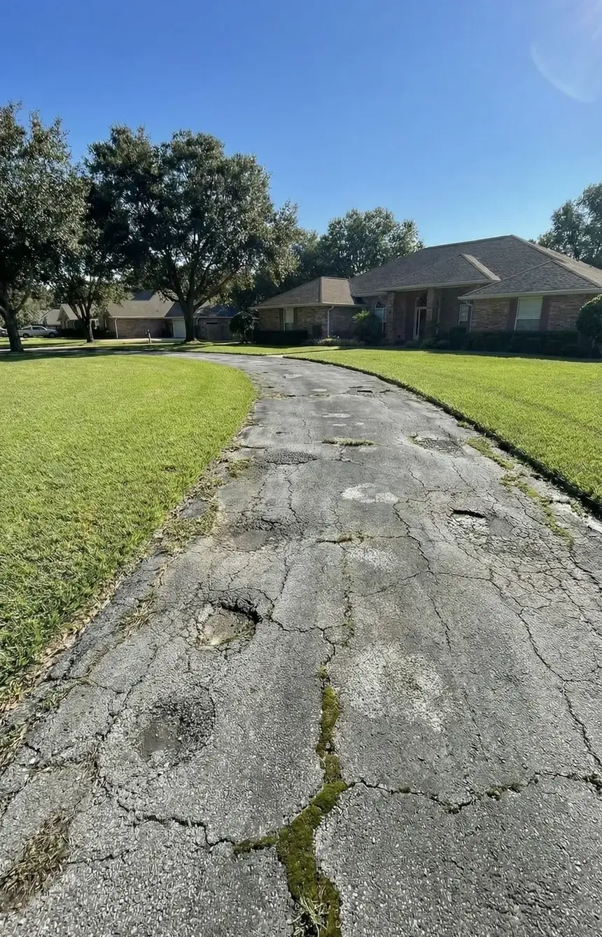 Same driveway before sealcoating, faded and cracked