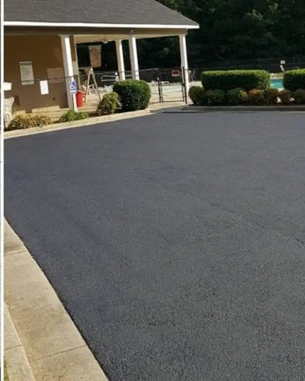 Finished sealcoated parking pad in front of a clubhouse