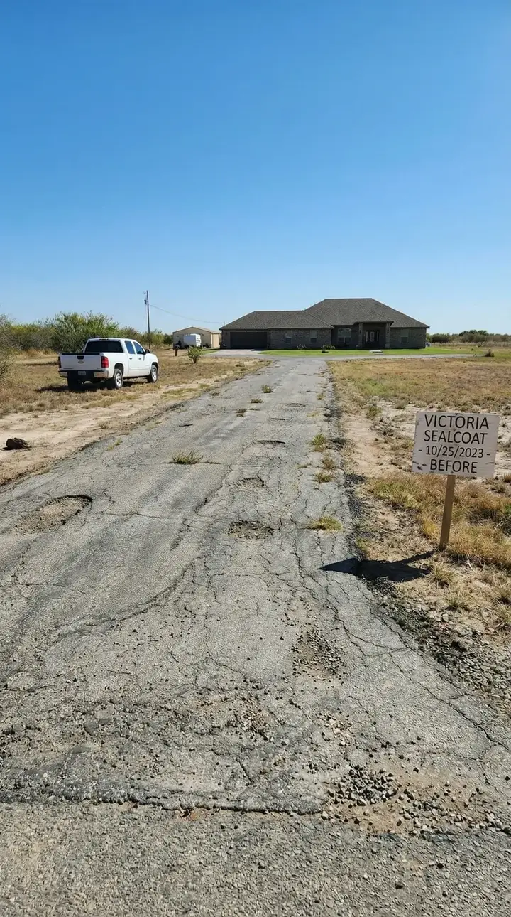 Deteriorated driveway before restoration, marked with a before sign