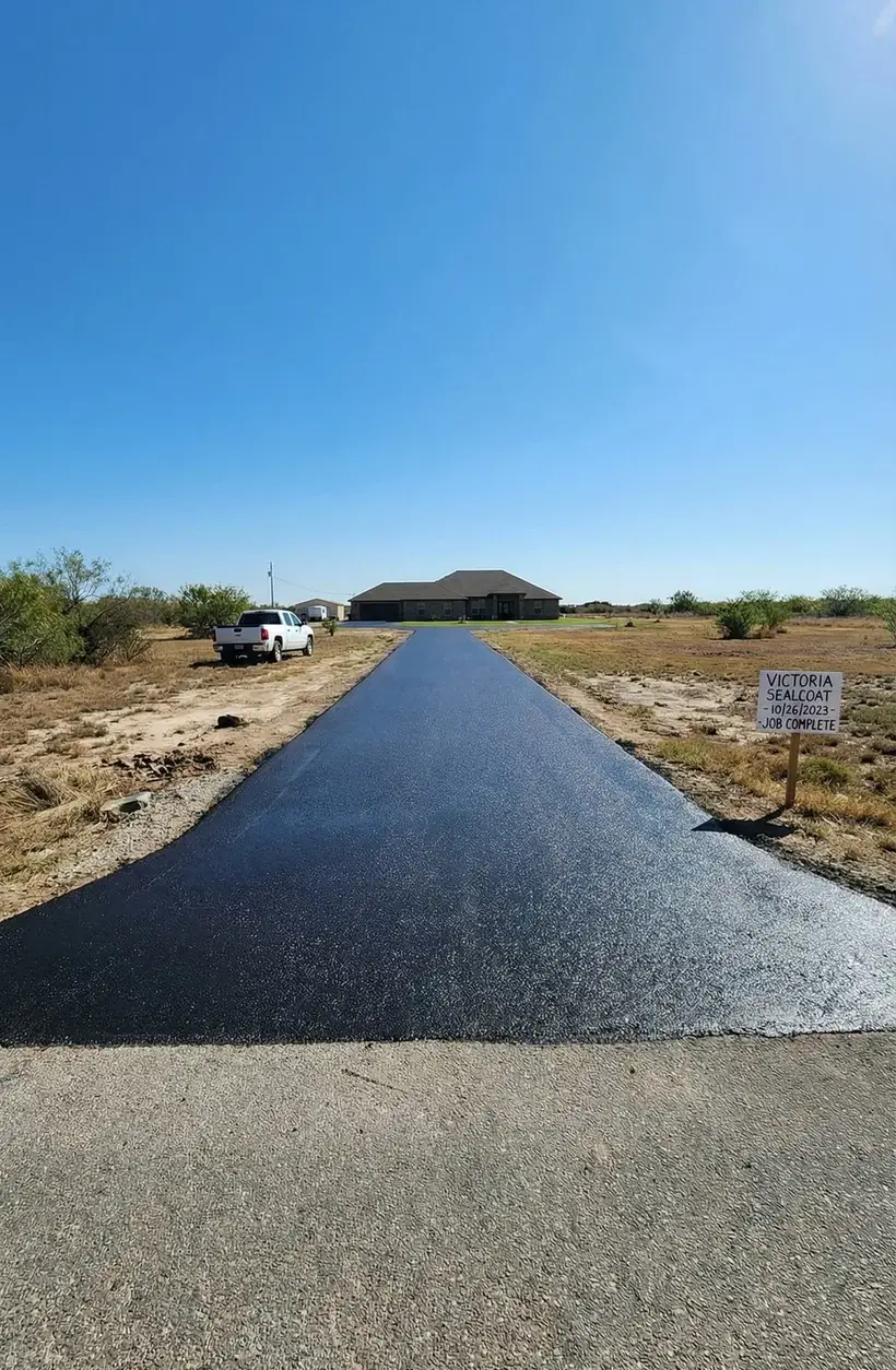 Restored asphalt driveway after repair and sealcoating